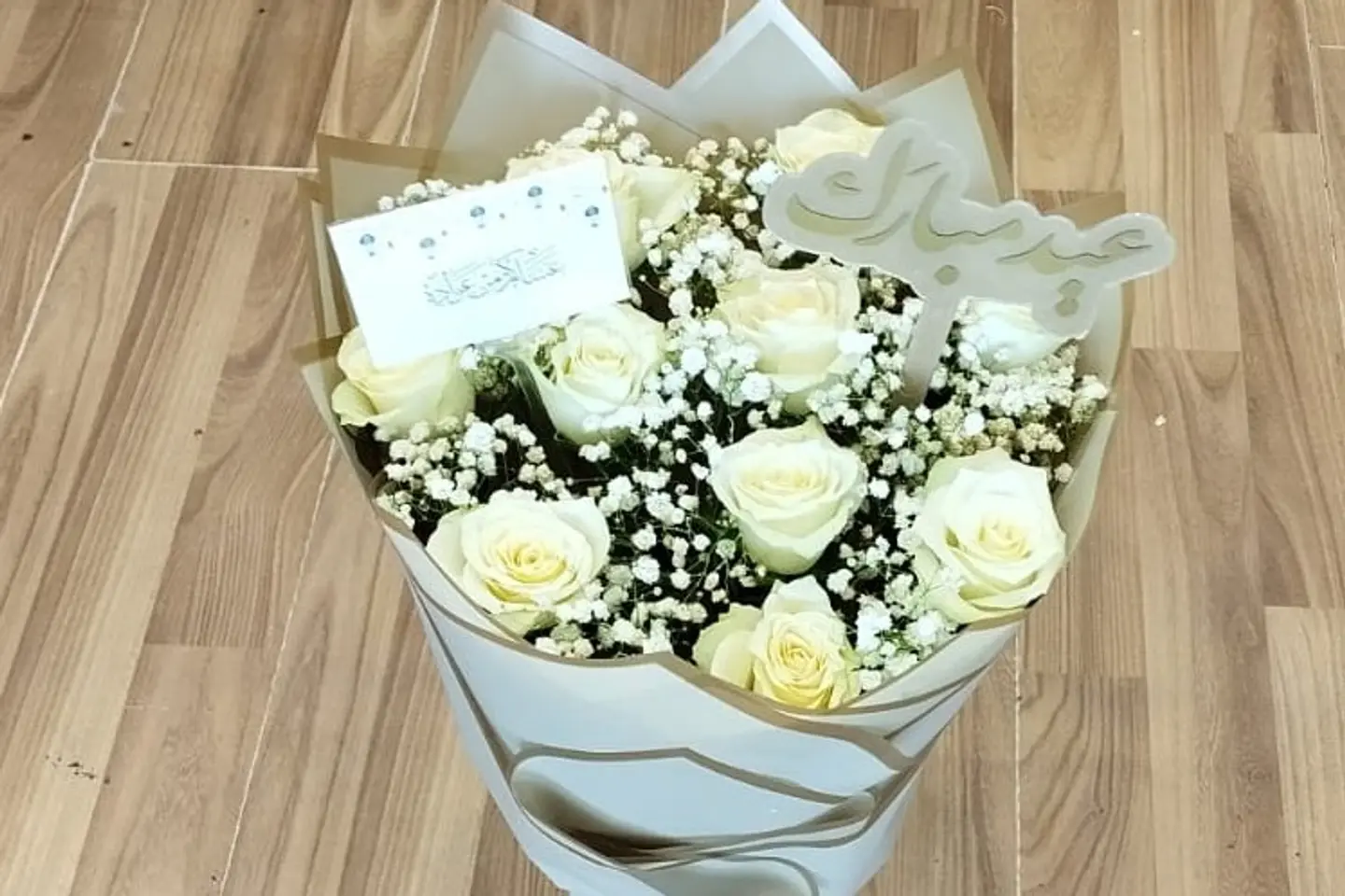 A Round Bouquet Of White Roses With A Happy Eid Greeting Card
