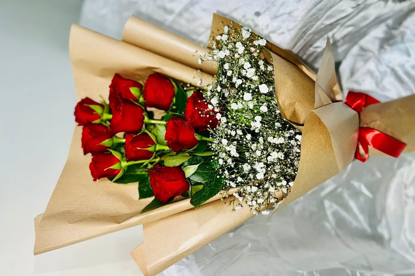 الورود الحمراء والوردية مع الأوراق الخضراء