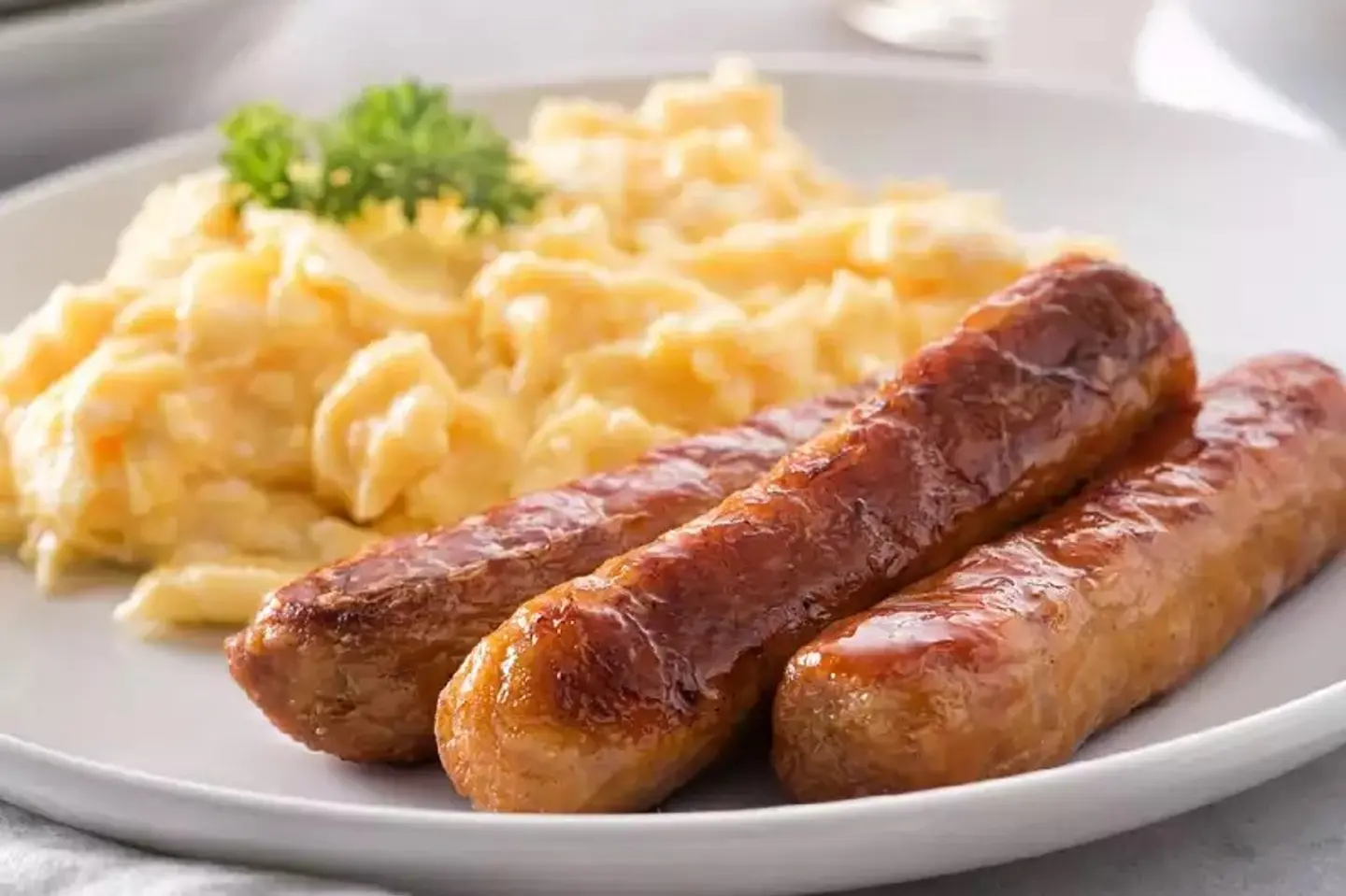 Two Scrambled Eggs With Sausage