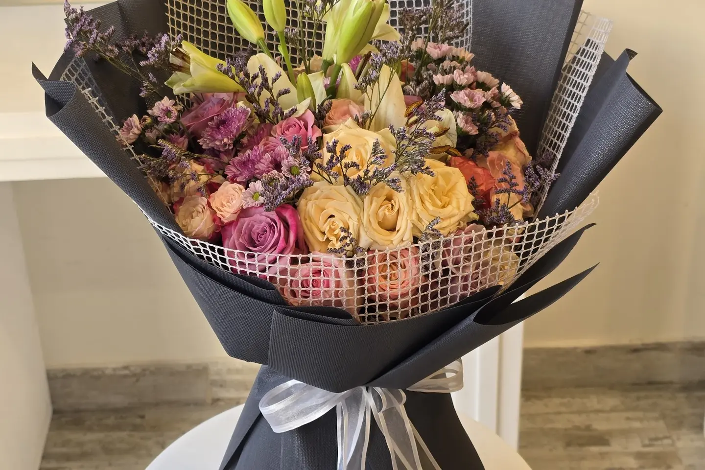 A Gray Wrapped Bouquet Of Flowers