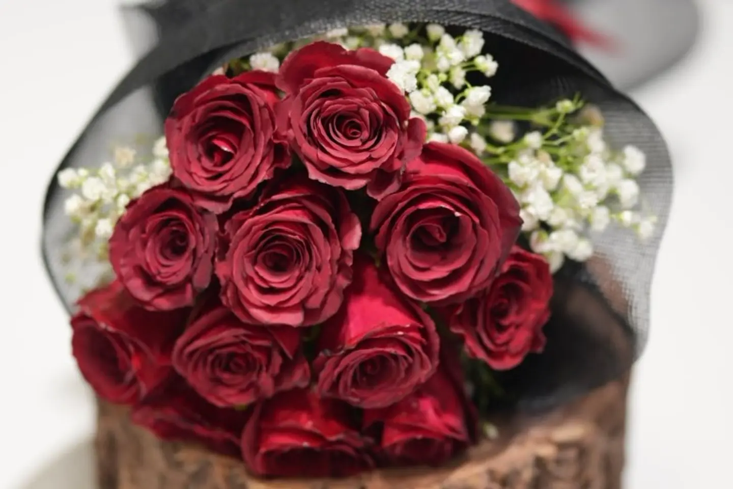 A Bouquet Of Red Roses And White Flowers