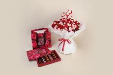 A Bouquet Of Dahlia Flowers And Luxurious Belgian Tulane Chocolates