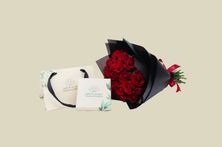 A Bouquet Of Red Roses And Tolin Chocolate