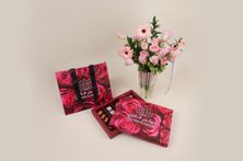 A Vase Of Enchanting Flowers And Luxurious Belgian Tollen Chocolate