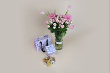 A Vase Of Soft Flowers And Luxurious Belgian Tollen Chocolate