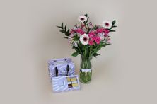 A Vase Of Spring Petals And Luxurious Belgian Tuline Chocolate