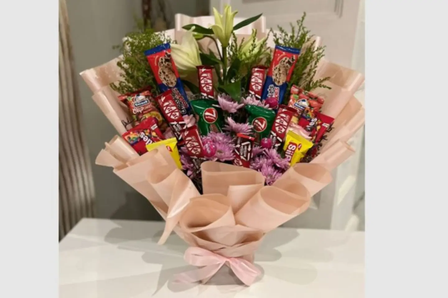 A Bouquet Of Flowers And Eid Sweets