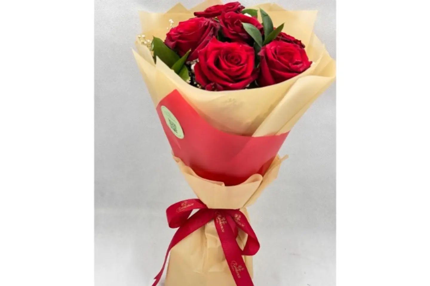 A Bouquet Of Roses With Elegant Packaging