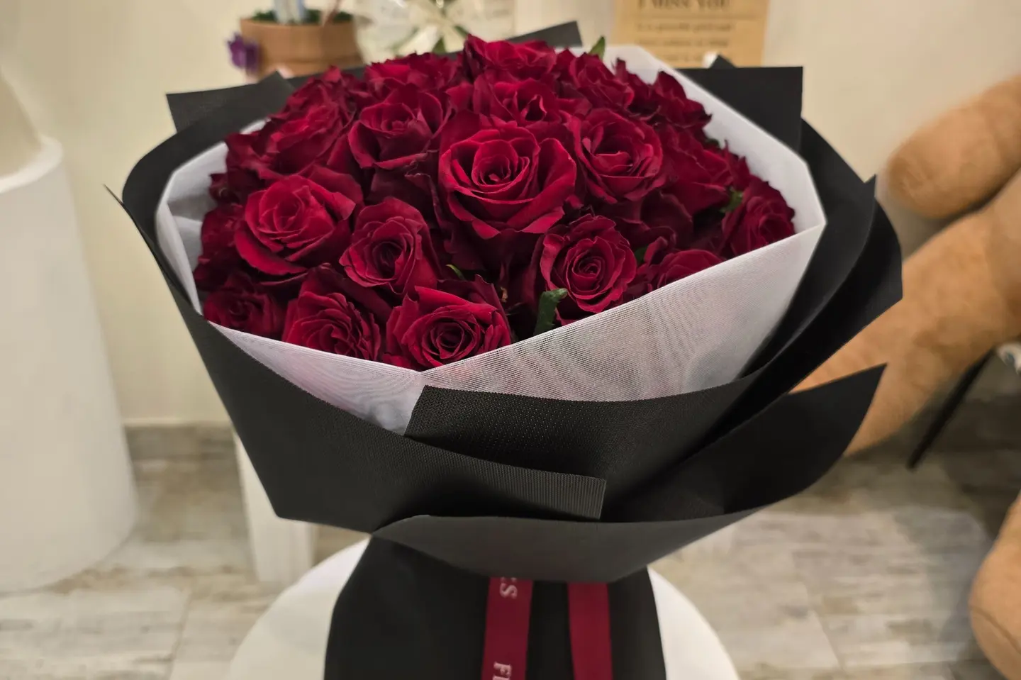A Bouquet Of Forty Red Roses With Black Wrapping