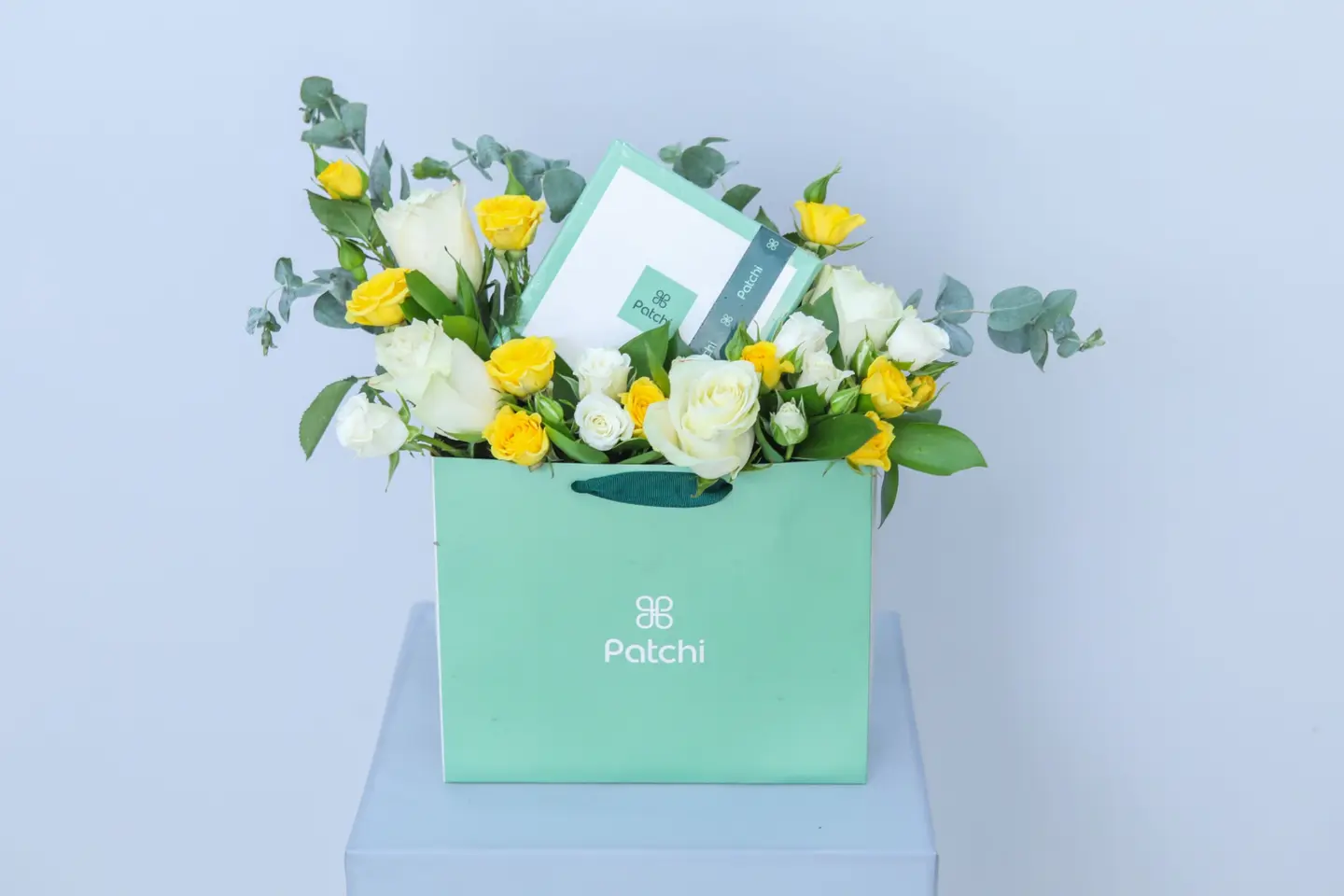 A Bouquet Of Flowers And Patchi Chocolates