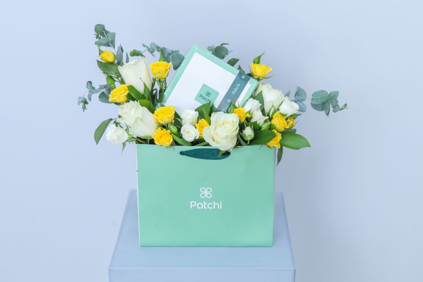 A Bouquet Of Flowers And Patchi Chocolates