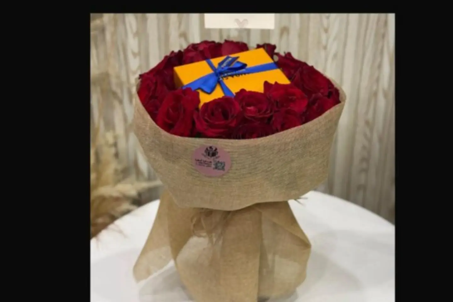 Louis Vuitton Chain In The Middle Of A Bouquet Of Red Roses