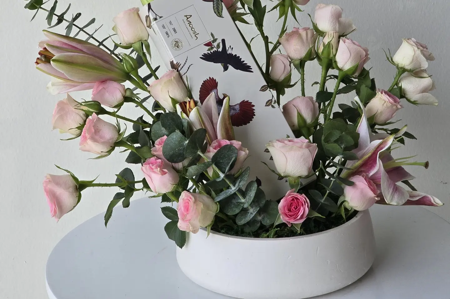 A Vase Of Flowers With Anoush Chocolate