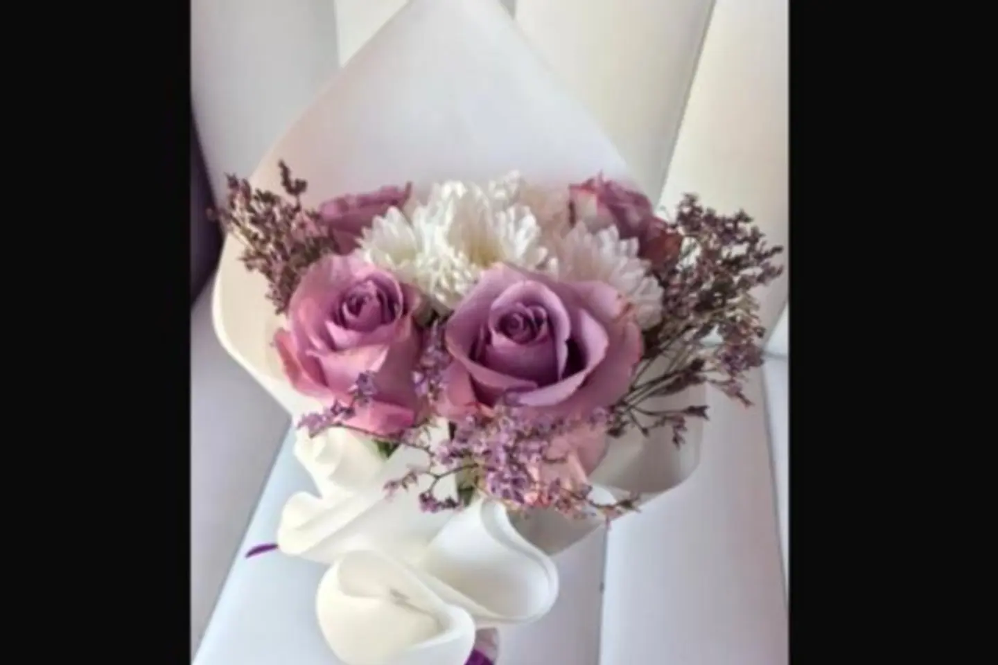 A Bouquet Of Purple Roses And White Cherries