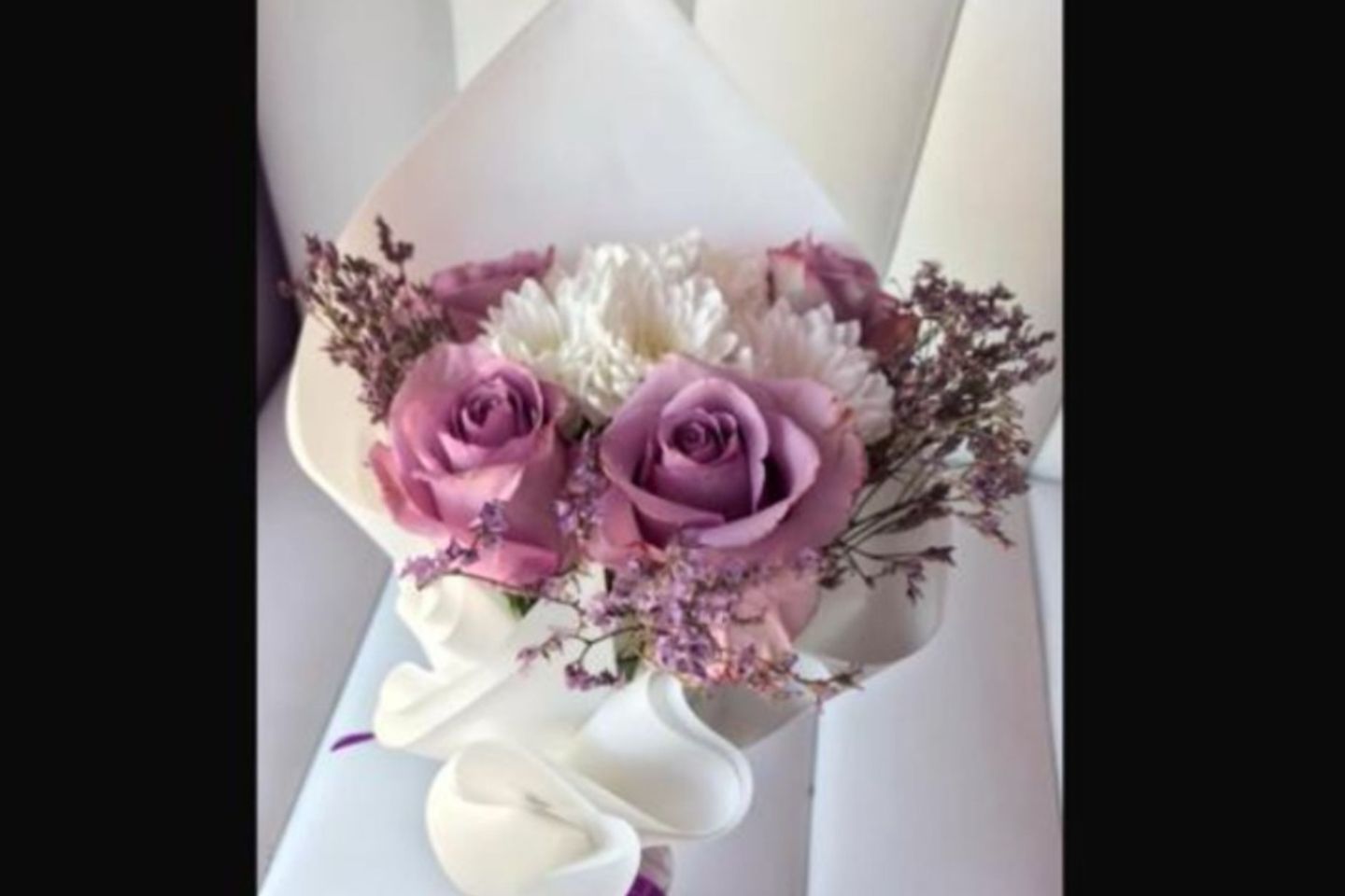 A Bouquet Of Purple Roses And White Cherries