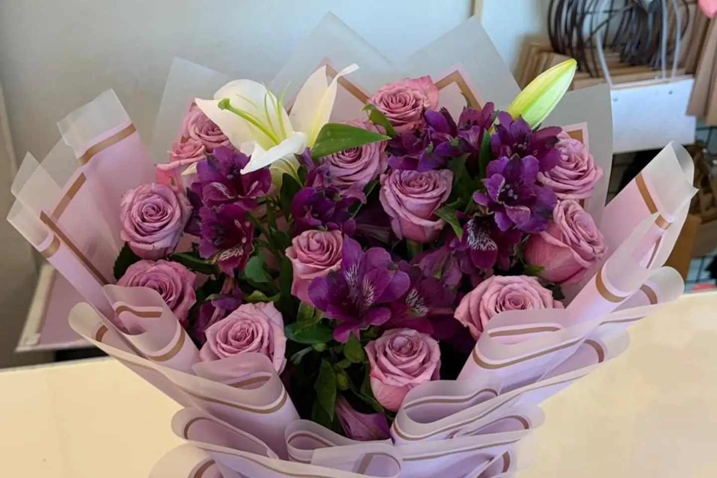 Bouquet With Purple Wrapping And Colorful Roses