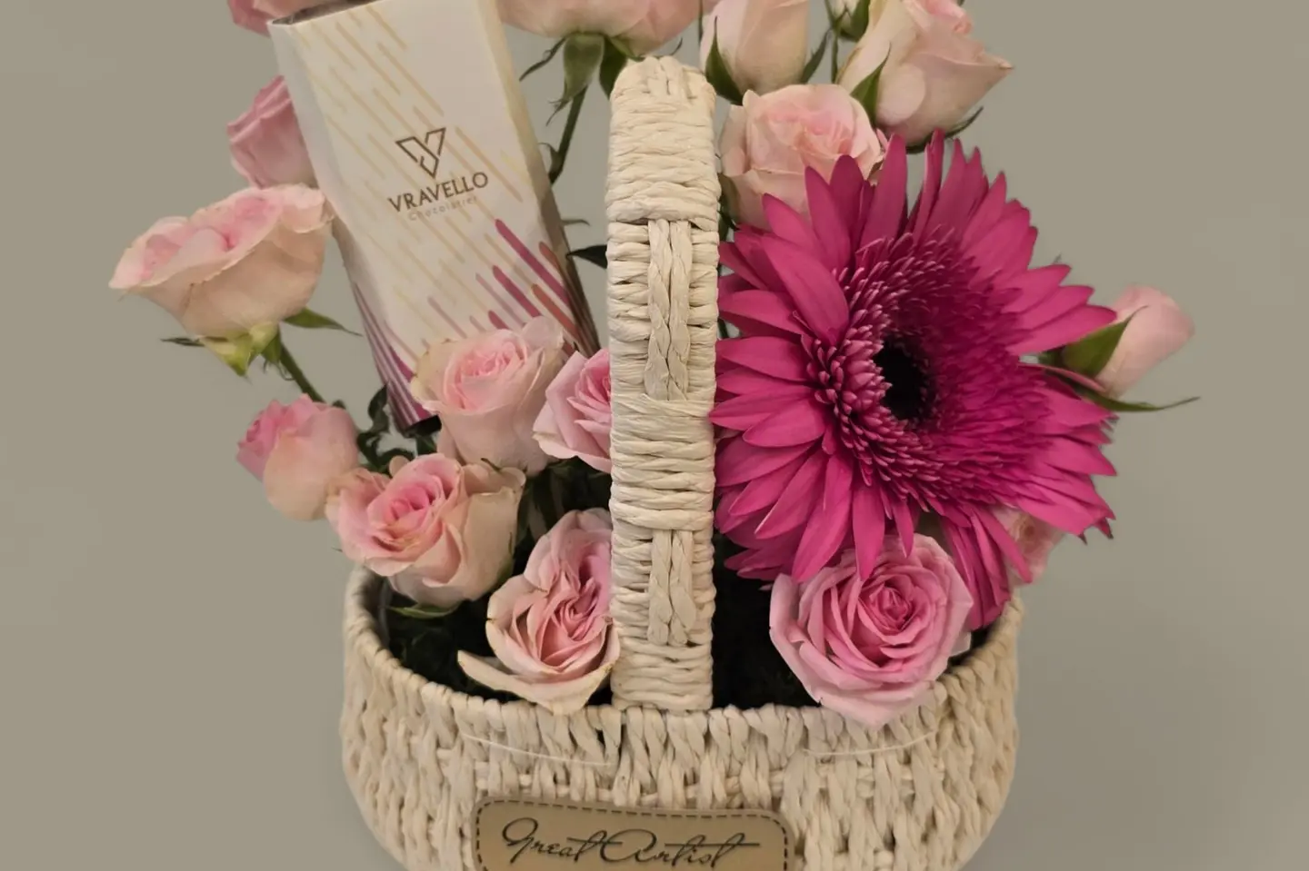 A Basket Of Flowers And A Pomegranate Chocolate Bar