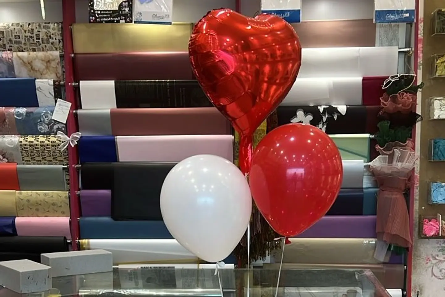 A Red Tin Heart And Two Helium Balloons