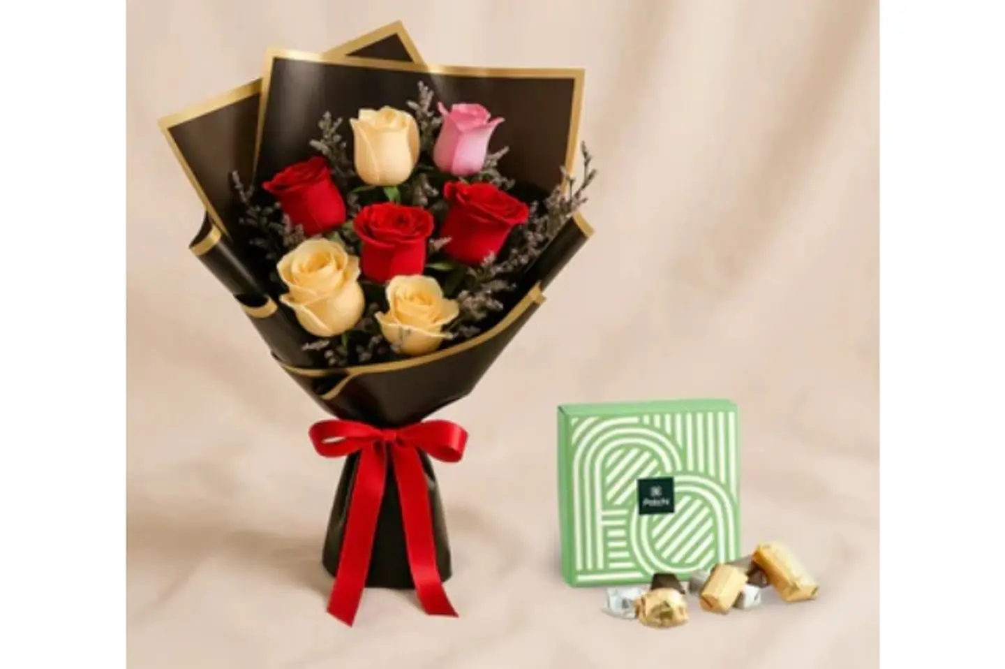A Bouquet Of Seven Roses And Patchi Chocolates