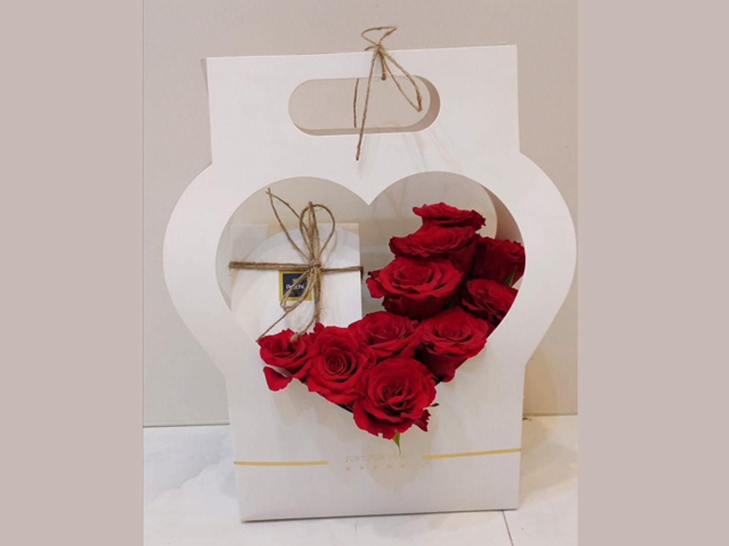 A Quarter Kilo Of Patchi Chocolate With Red Roses