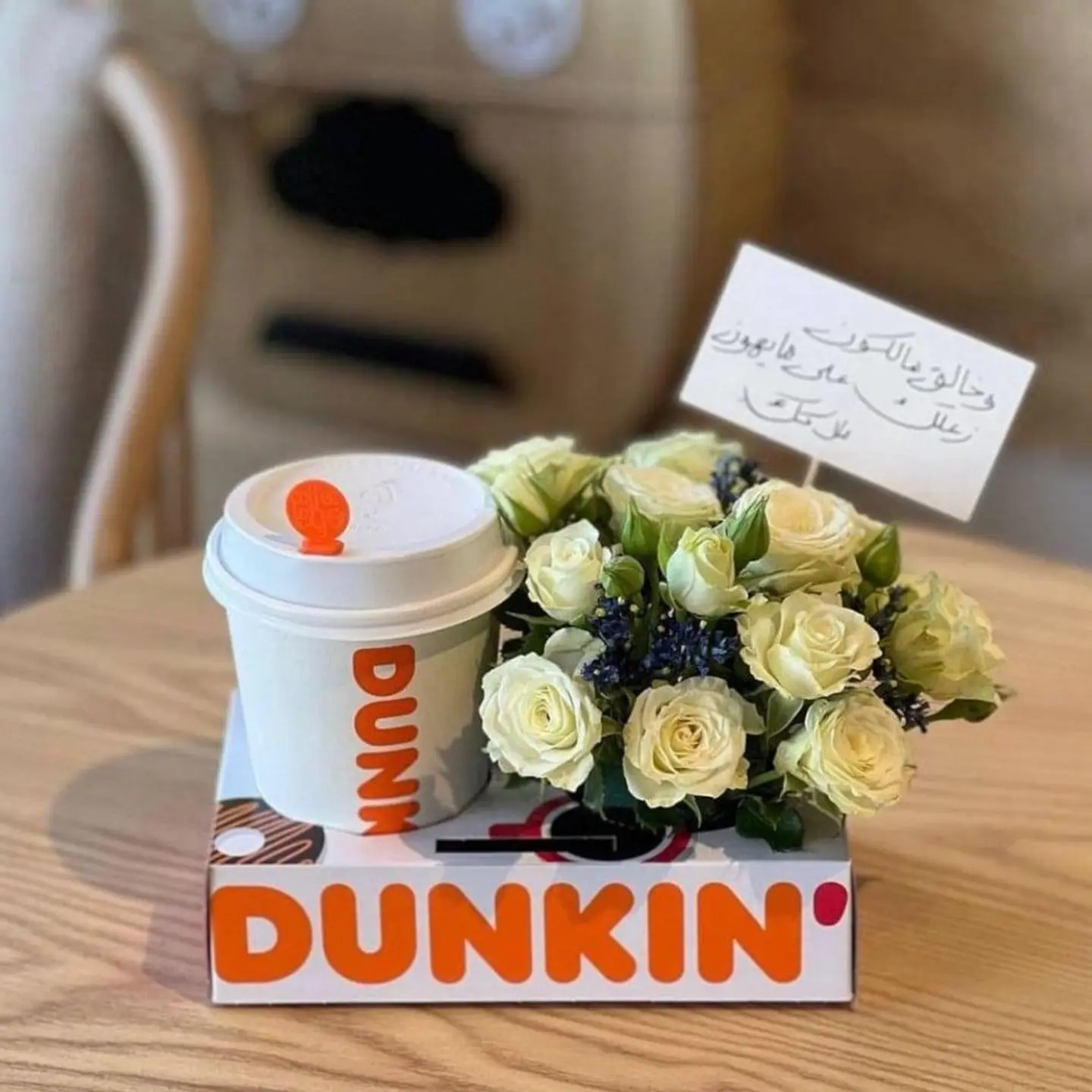 A White Rose Arrangement With Coffee