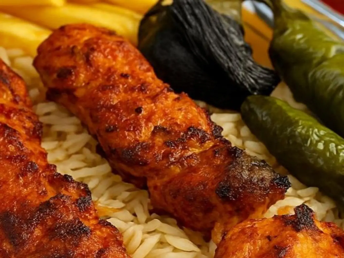 A Plate Of 2 Shish Tawook Skewers With Rice