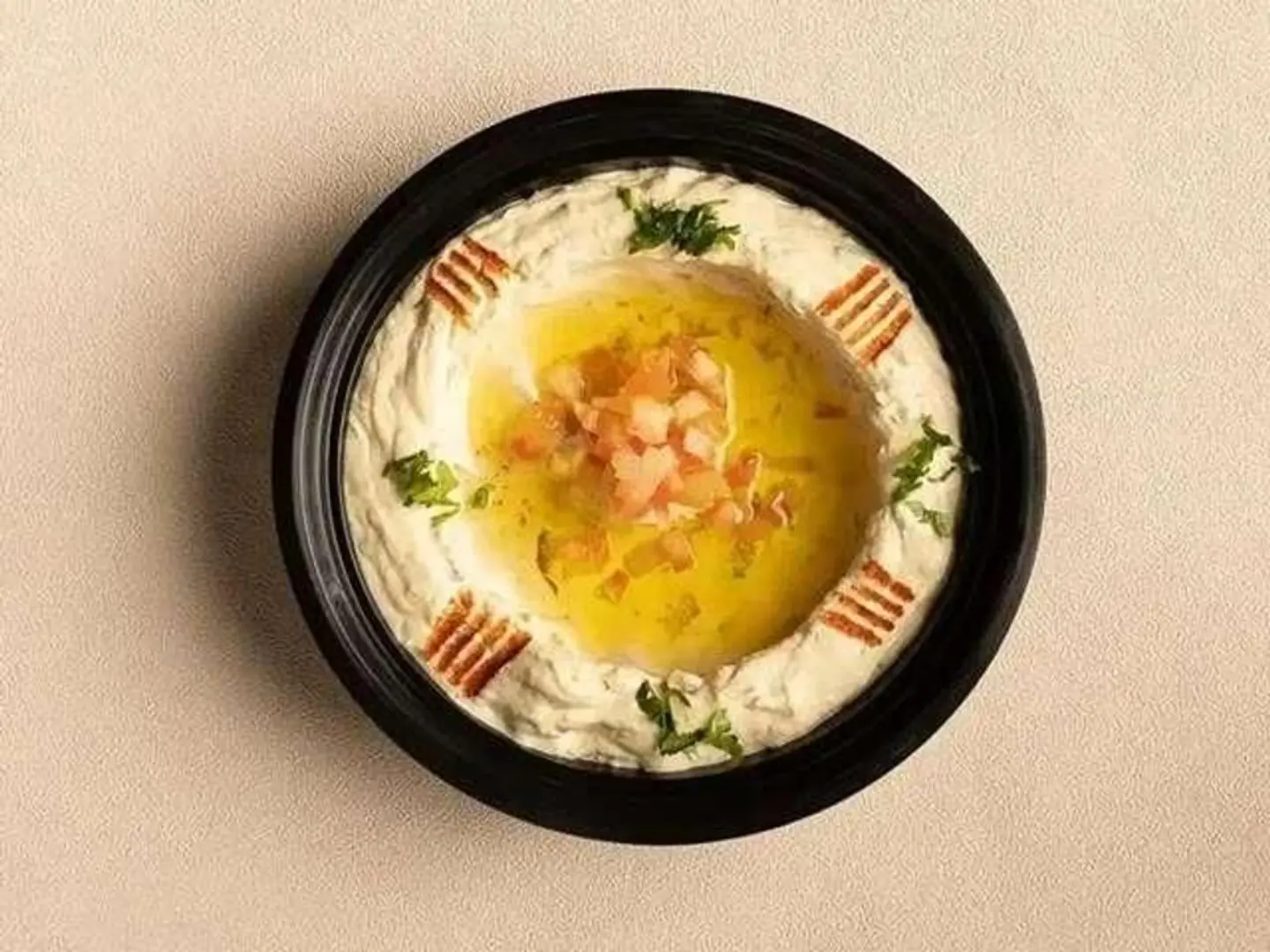 Hummus Mixed With Tomatoes, Parsley, And Spices