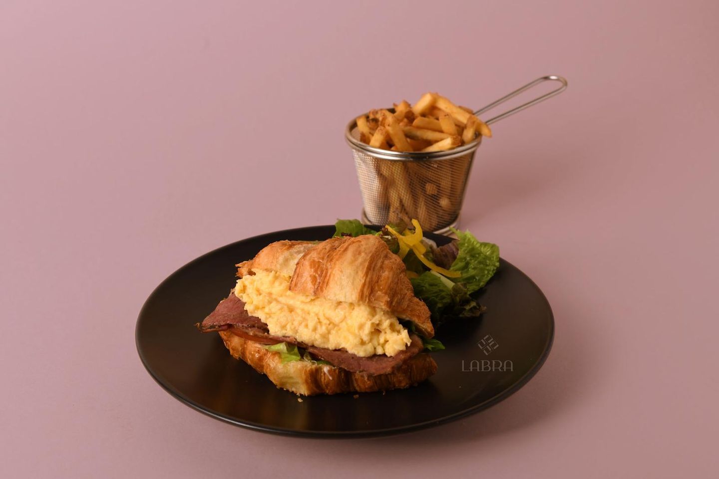 Croissant With Scrambled Eggs And Bacon Slices