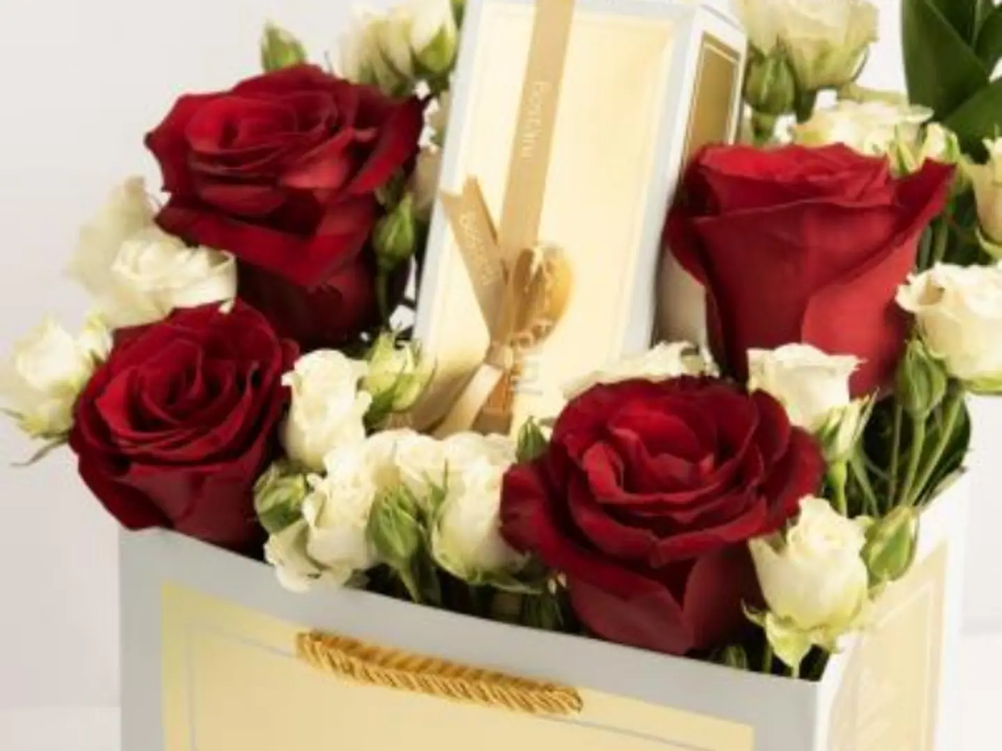 A Quarter Gardener Of Red Roses And A White Baby Rose