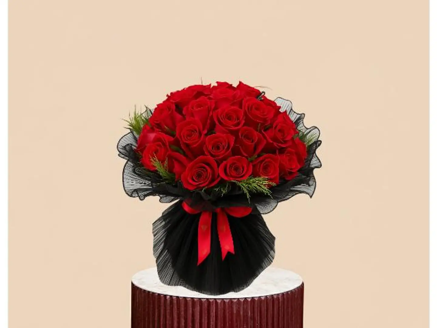 A Red Rose Bouquet Wrapped In Luxurious Fabric