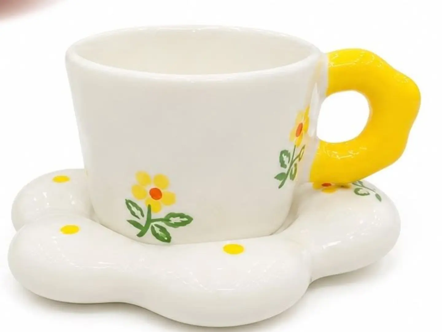A Set Of White And Yellow Ceramic Cups With A Flower Shaped Saucer And A Cute Yellow Handle.