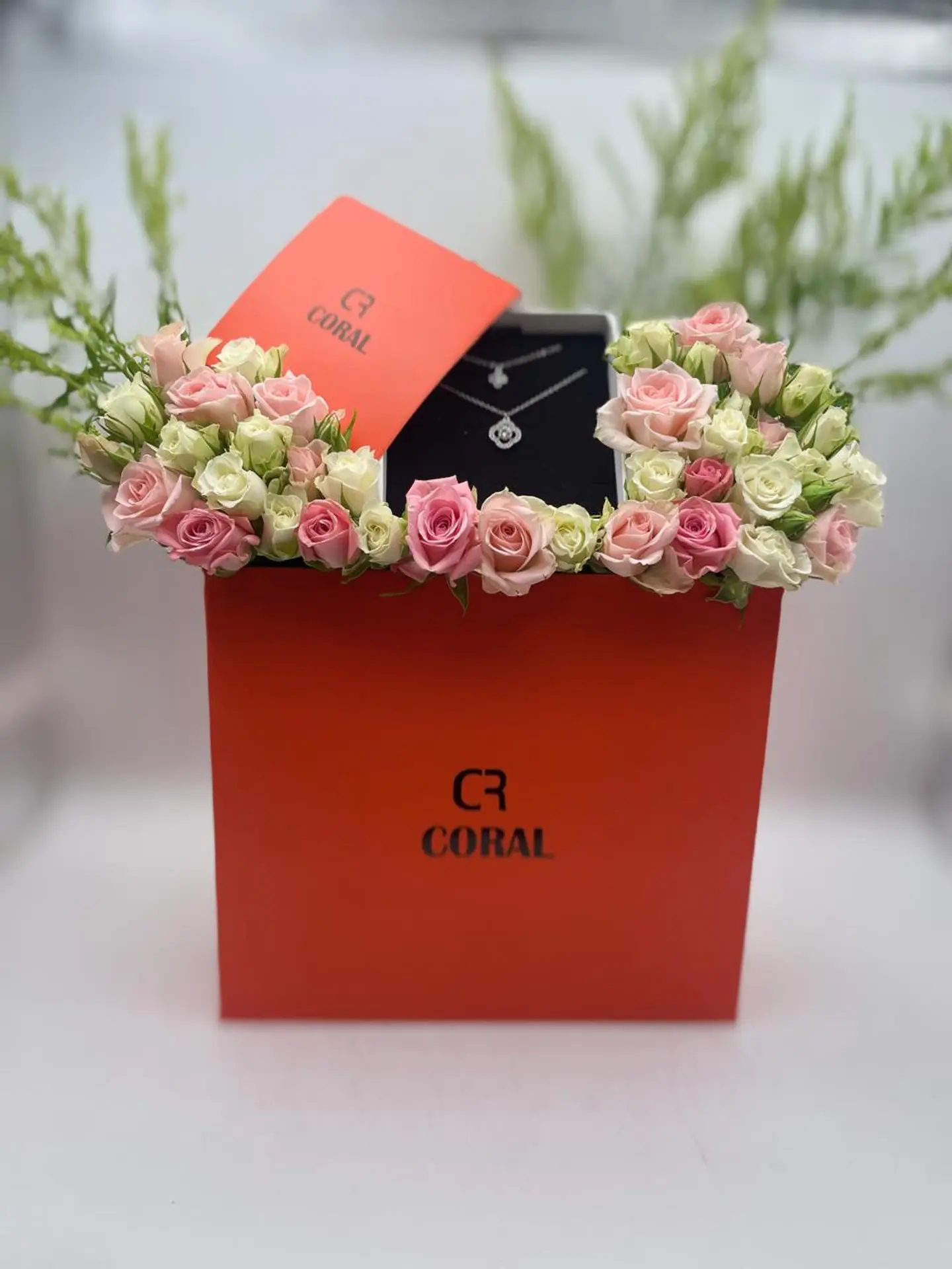 A Bouquet Of Roses With A Silver Necklace