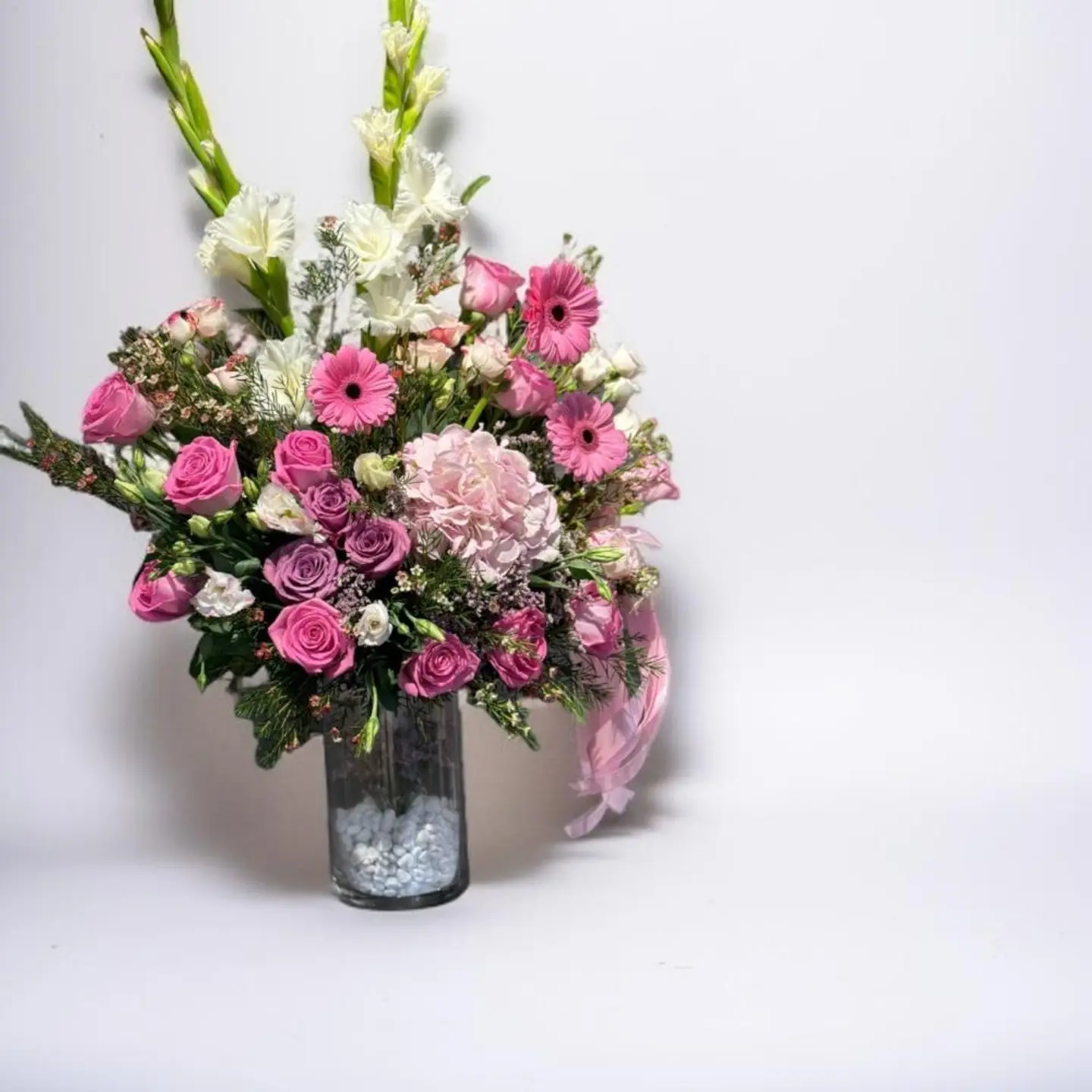 مزهرية زهور صغيرة وفروع خضراء