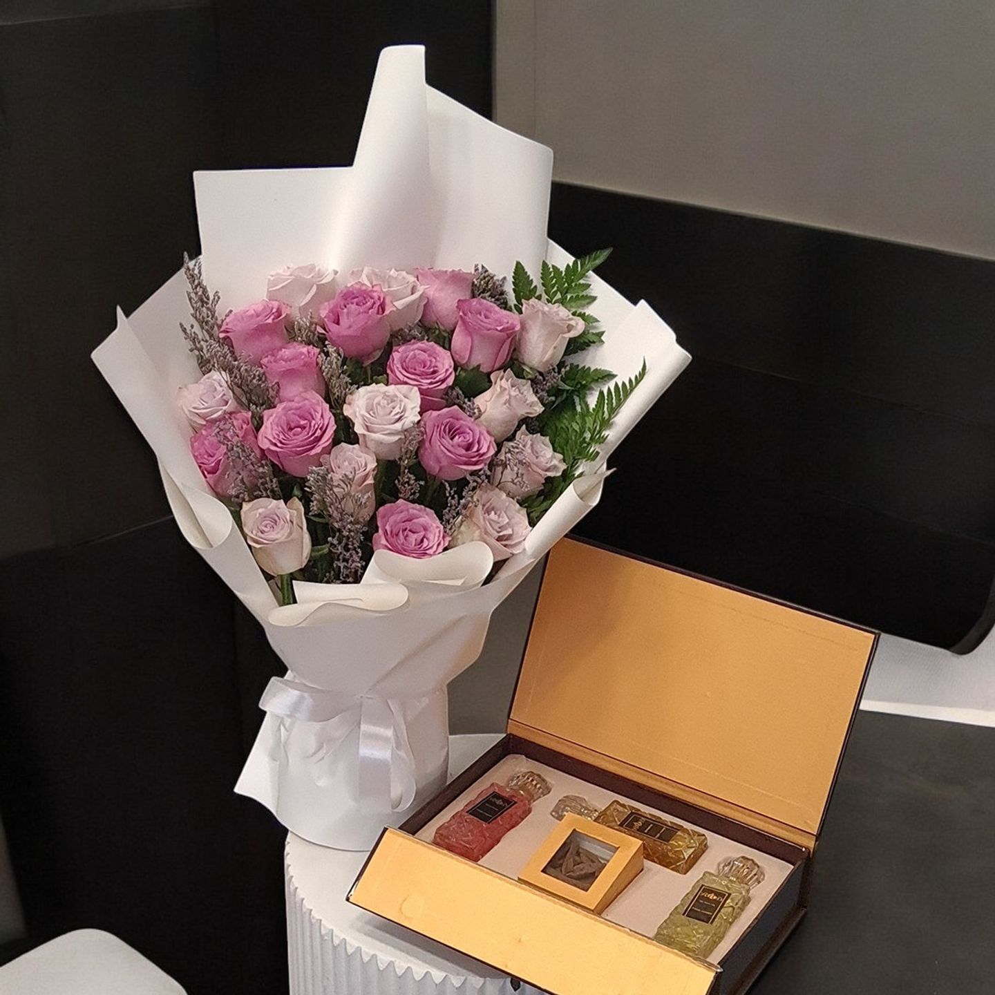 Love Of A Collection Of French Perfumes, Oud And A Bouquet Of Roses