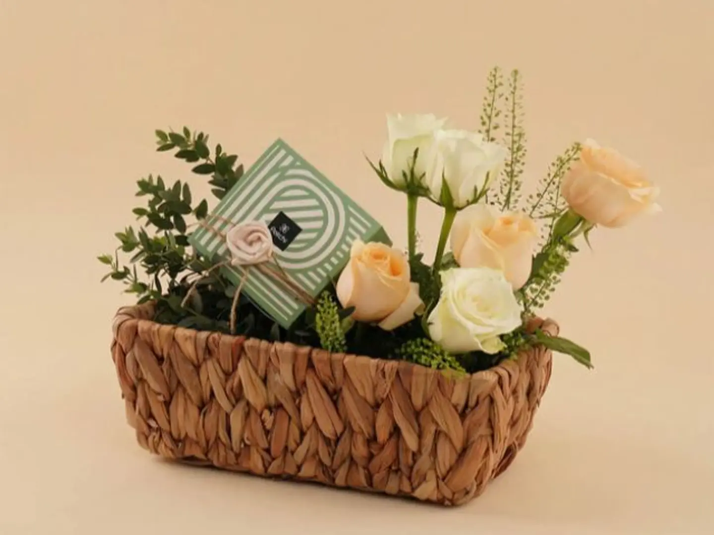 A Basket Of Roses With A Box Of Patchi Chocolates.