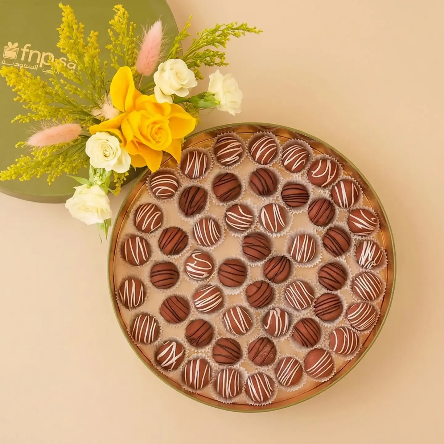 A Bouquet Of Roses And A Tray Of Chocolate Truffles