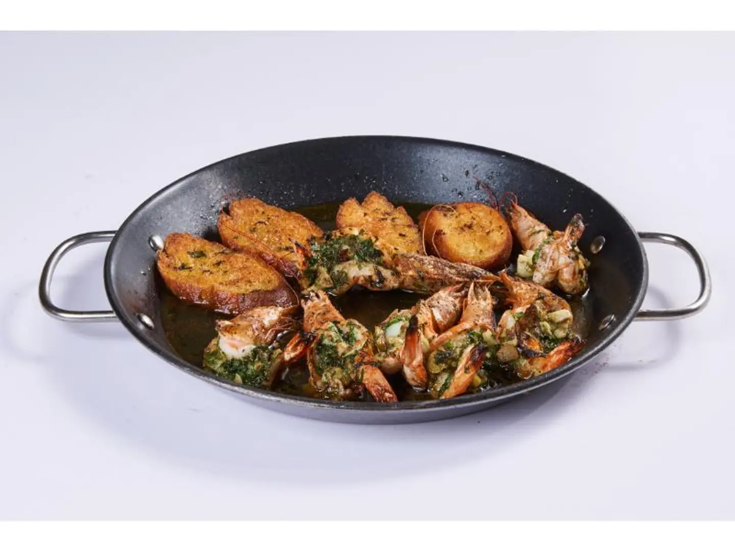 A Tray Of Cooked Shrimp With Butter And Garlic