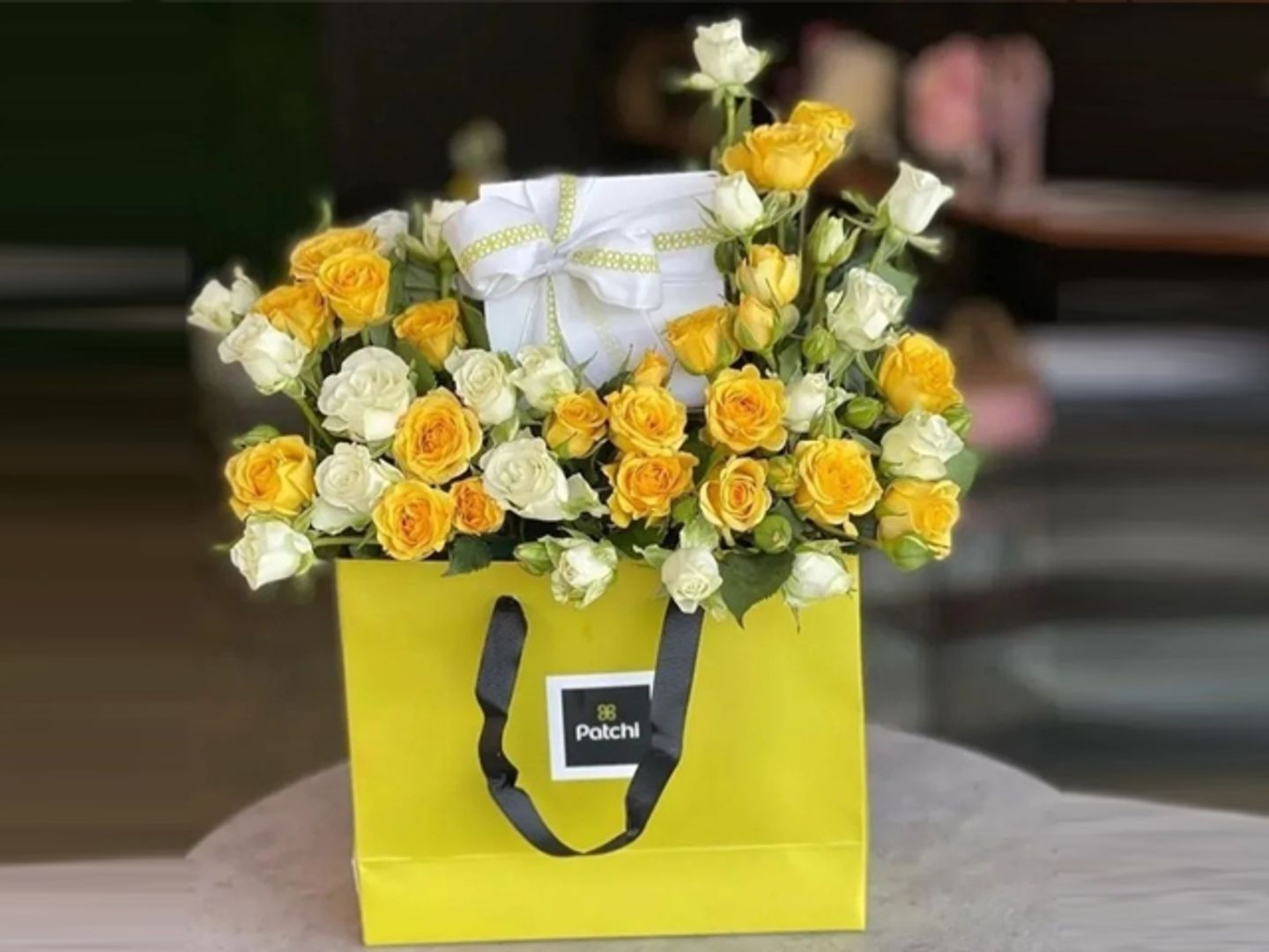 A Quarter Kilo Of Patchi Chocolate With Yellow And White Flowers