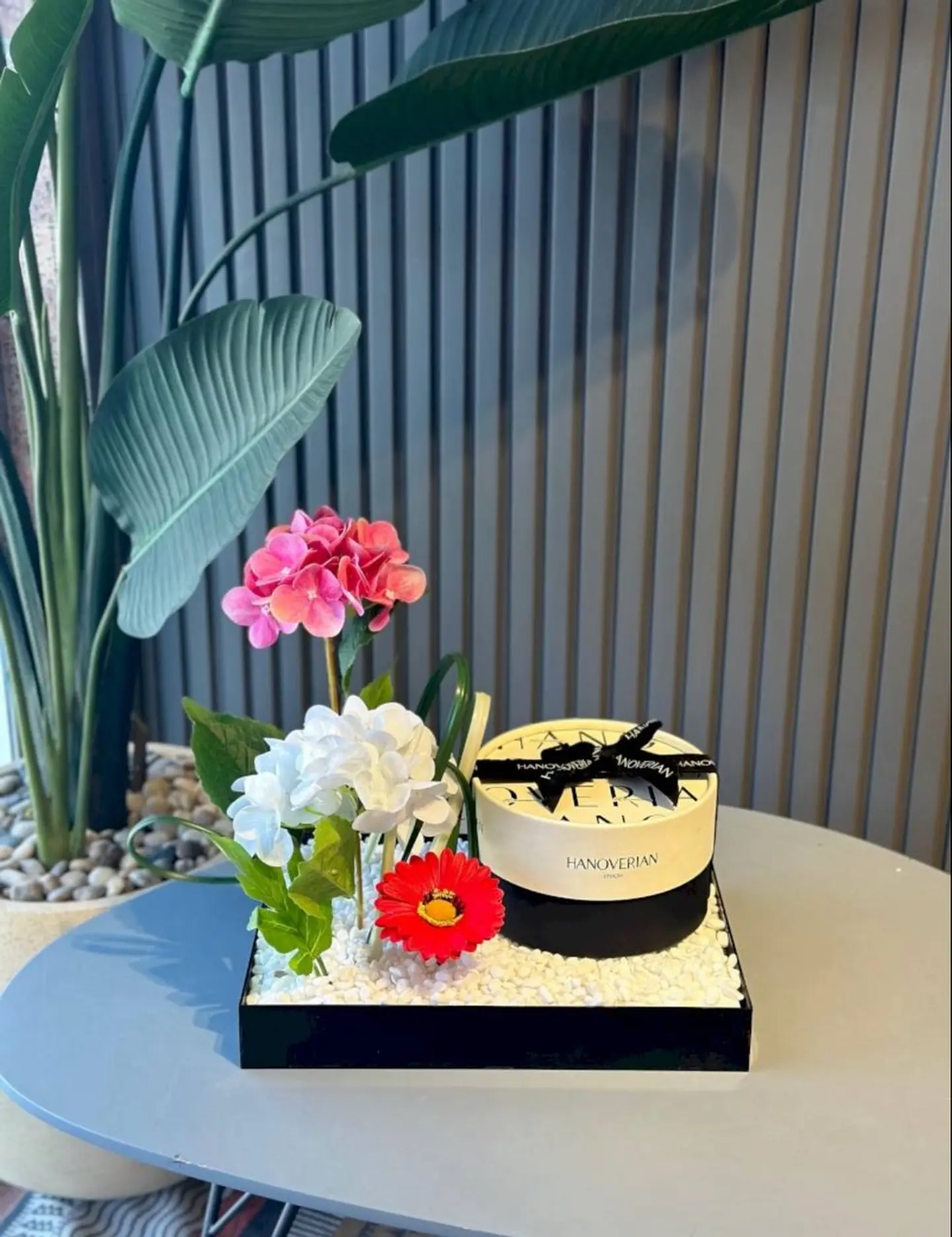 Hanoverian And Artificial Flower Arrangement On Acrylic