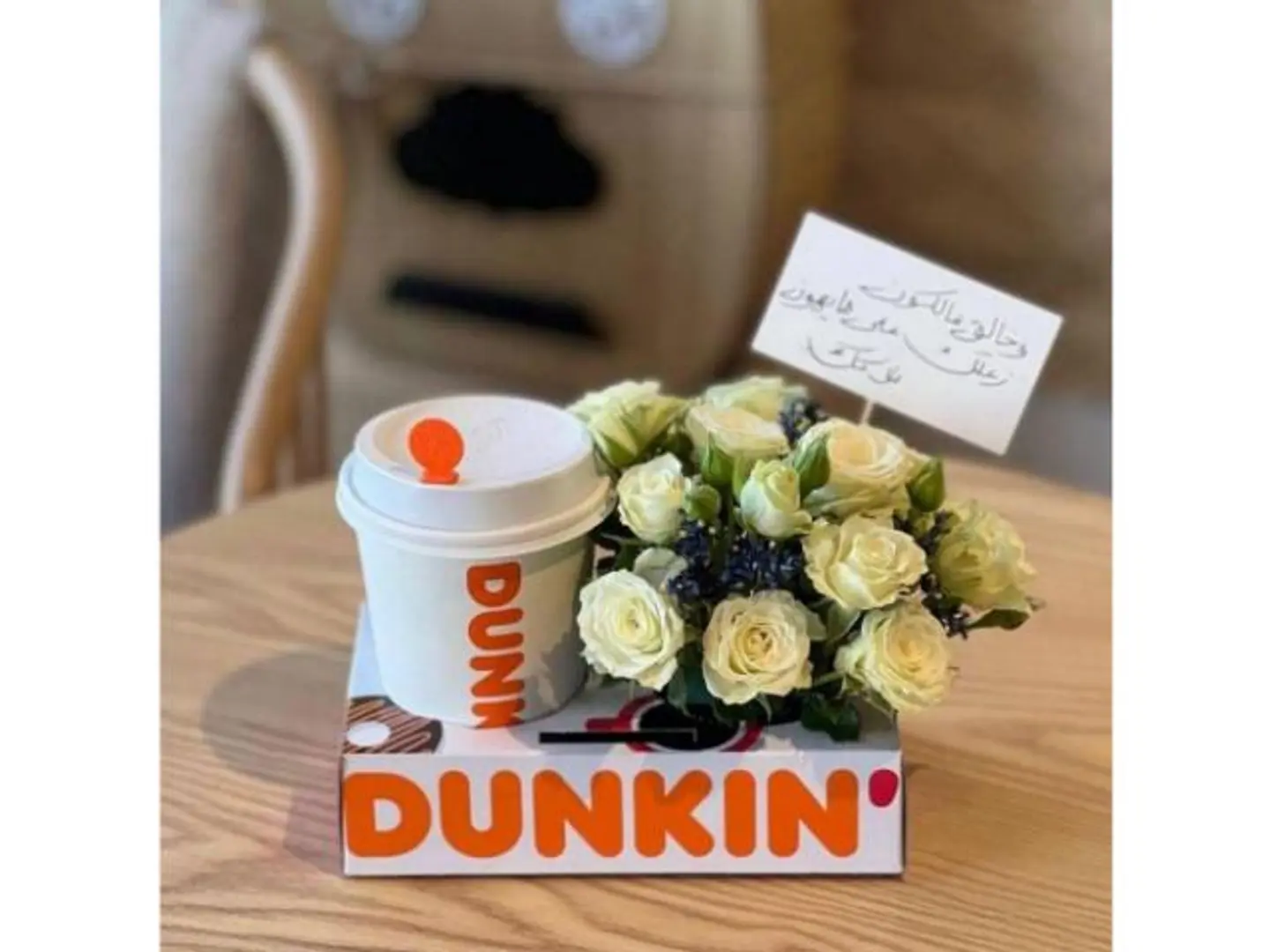 A White Rose Arrangement With Coffee