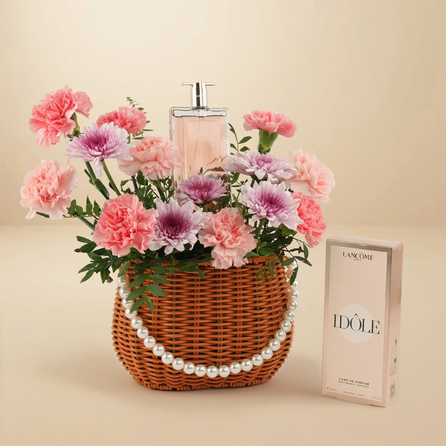 A Basket Of Pink Carnations With Idôle Le Grand Perfume For Women