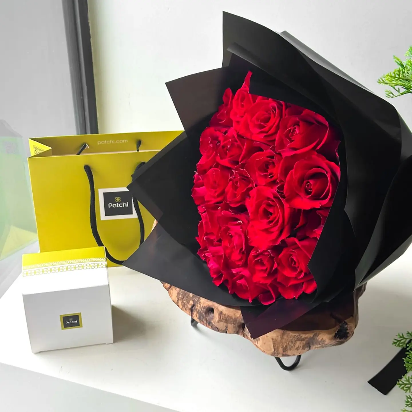 A Quarter Patchi With A Bouquet Of Red Roses And A Black Cover