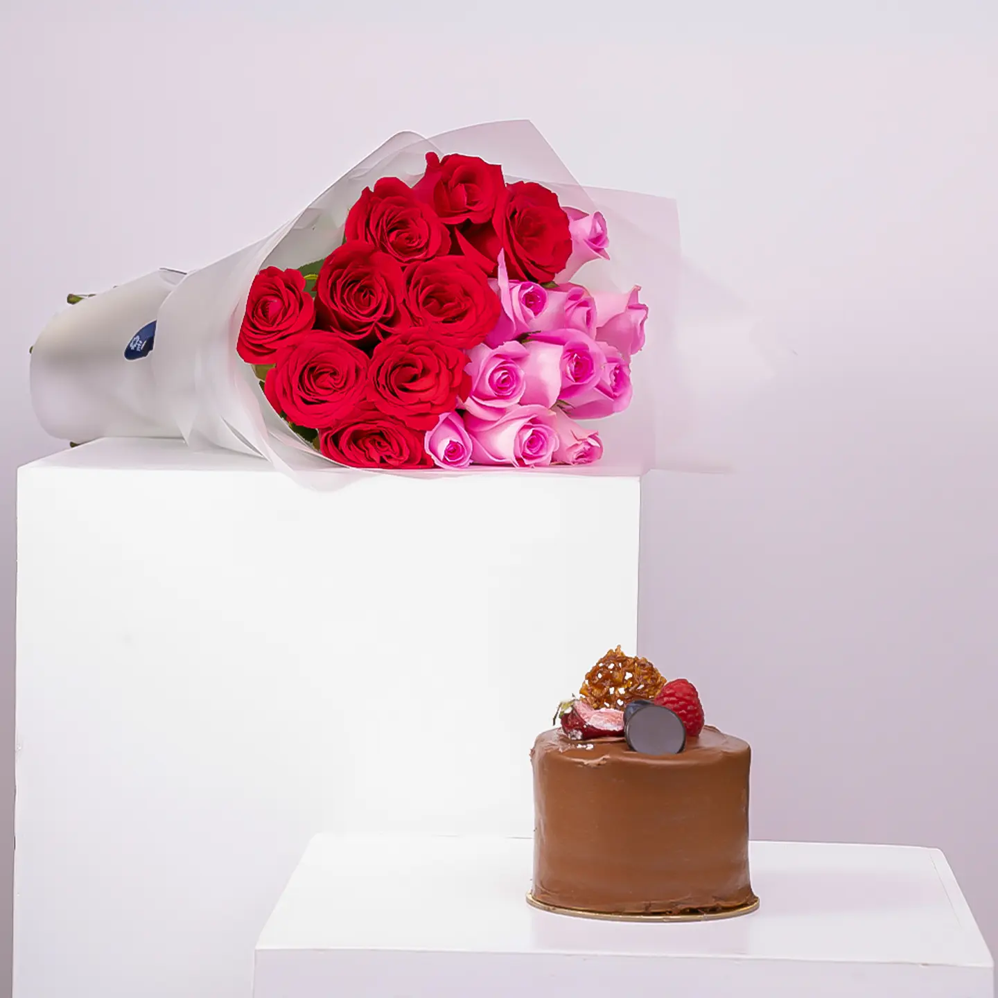 A Tiered Rose Bouquet With A Chocolate Cake