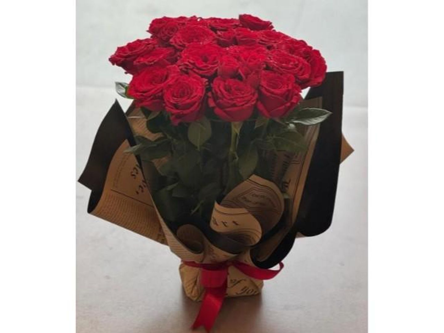 Red Bouquet Wrapped In Paper