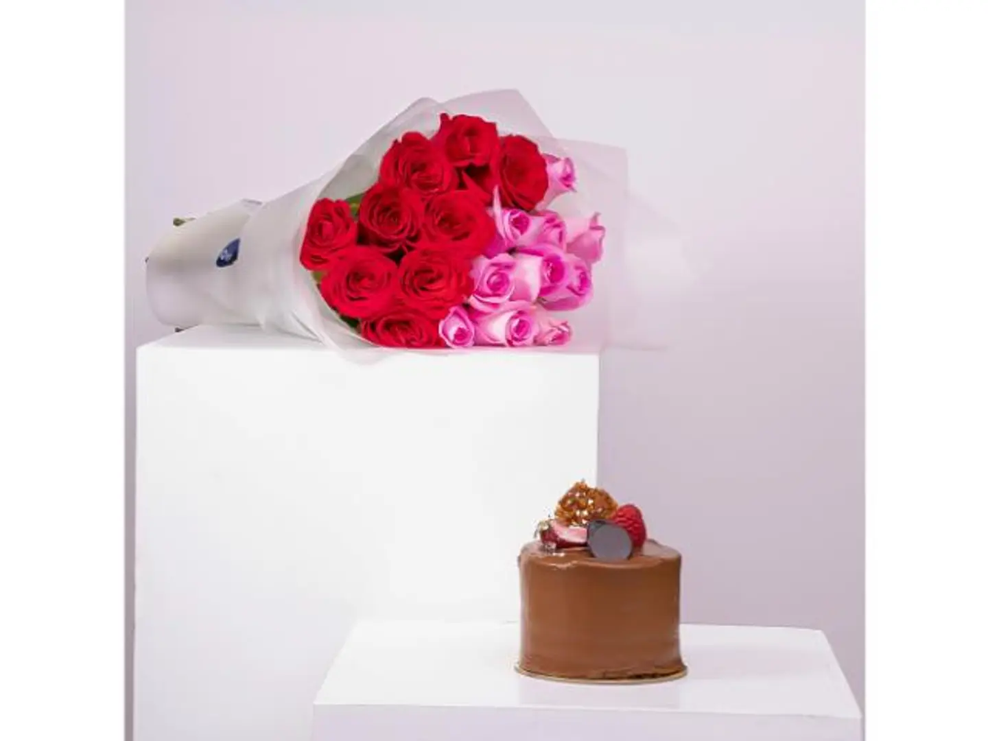 A Tiered Rose Bouquet With A Chocolate Cake