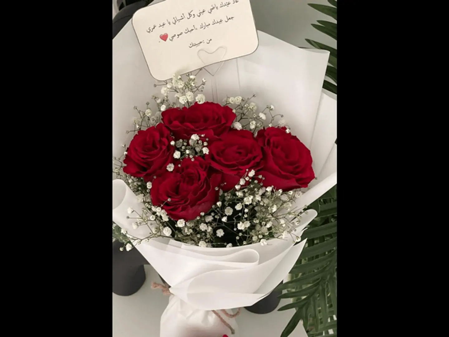 A Bouquet Of Five Red Roses And Gypsum Philia Branches White Wrapping