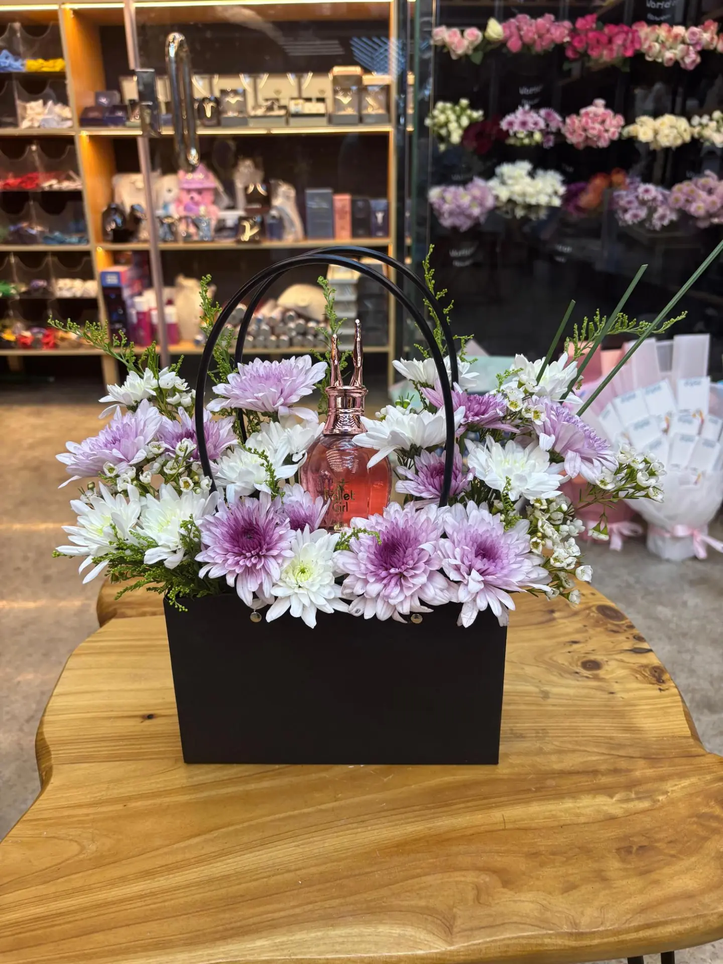 A Cardboard Bag Containing A Women's Perfume And A Natural Rose Mix.