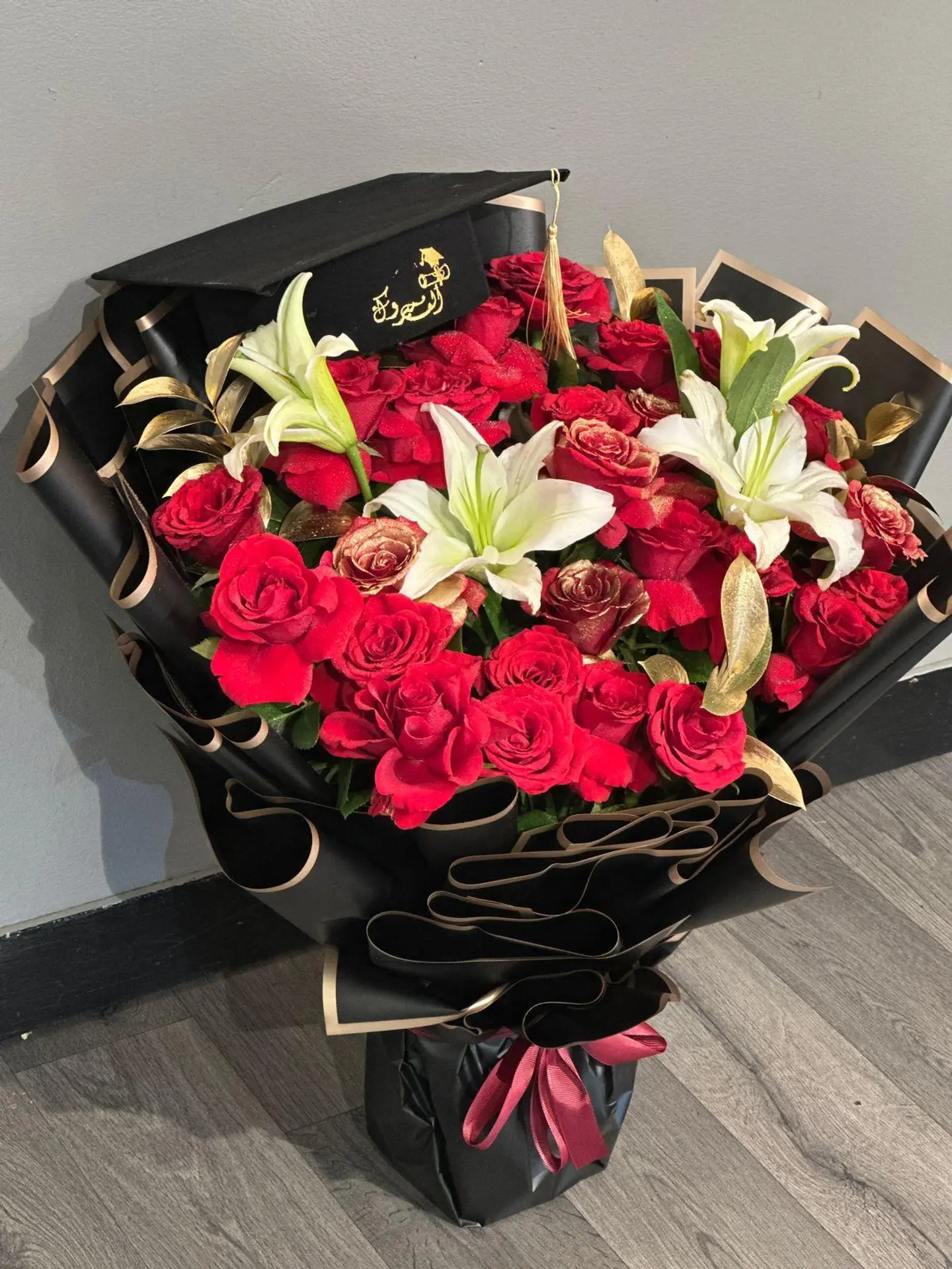 A Red Roses Bouqet With Congratulations Cap