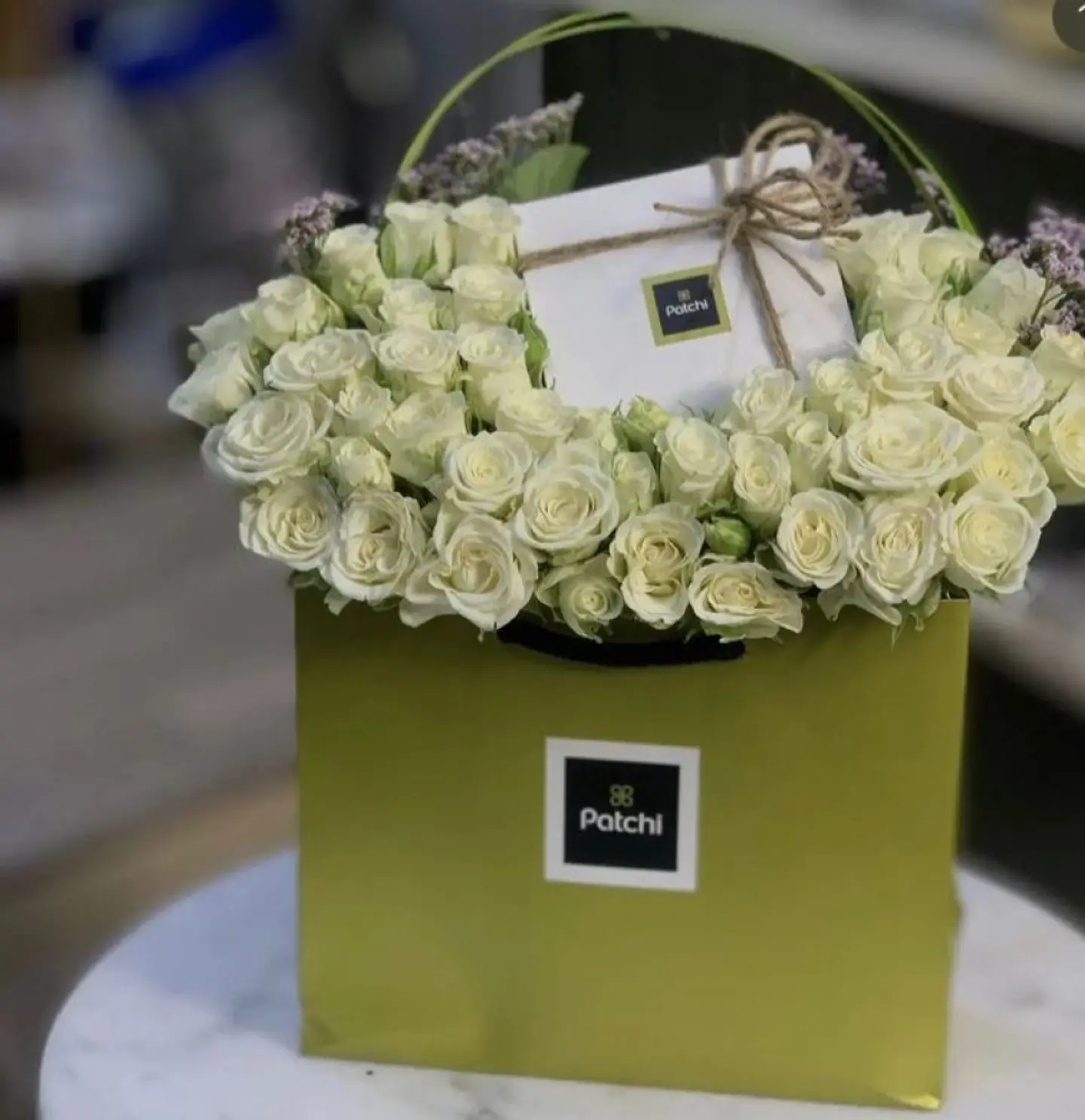 White Flower Arrangement And Patchi Chocolate