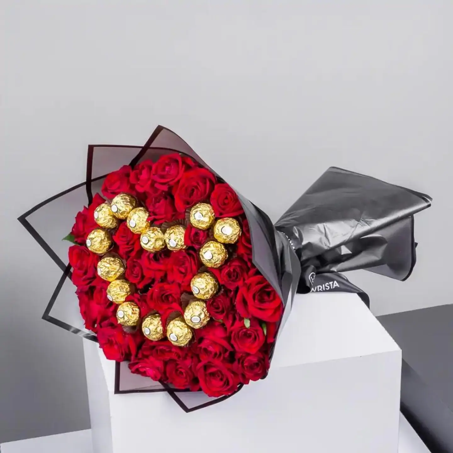 A Bouquet Of Red Roses With Chocolates